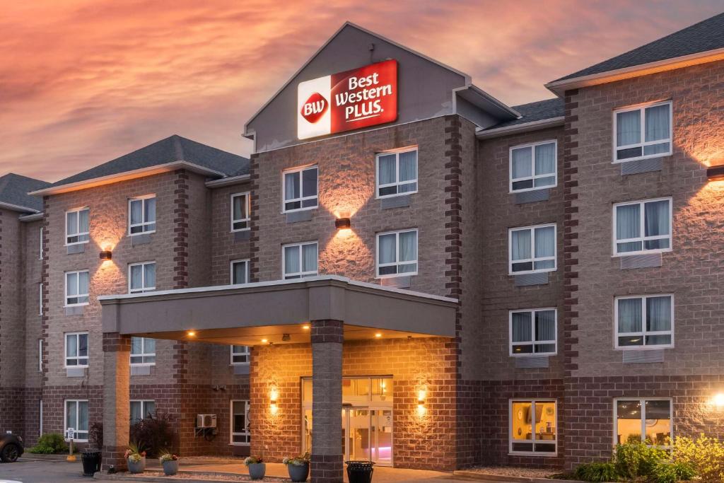 a hotel with a sign on the front of a building at Best Western Dartmouth Hotel & Suites in Halifax