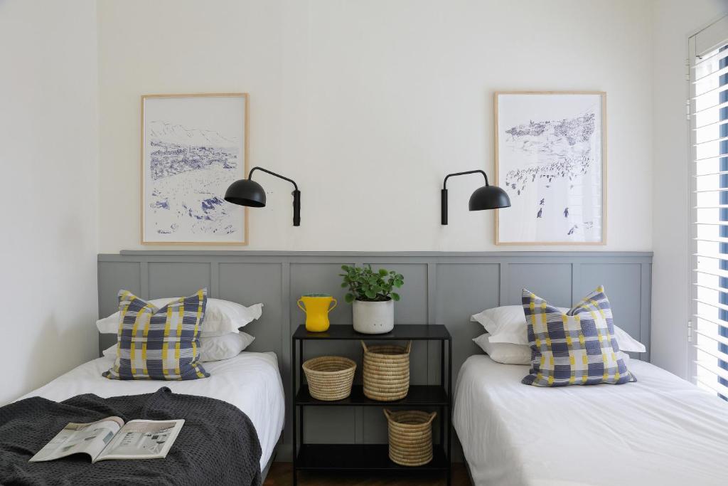 two beds sitting next to each other in a room at Waterkant House - 151 in Cape Town