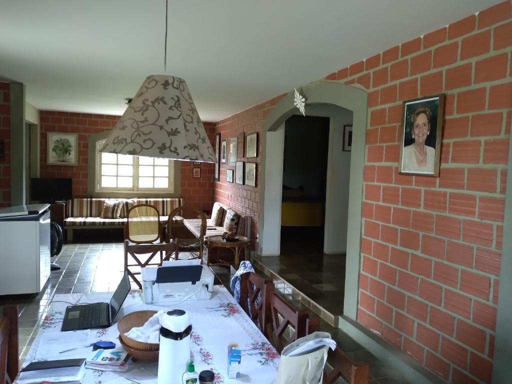 a kitchen and dining room with a brick wall at Casa com piscina em Gravatá PE in Gravatá