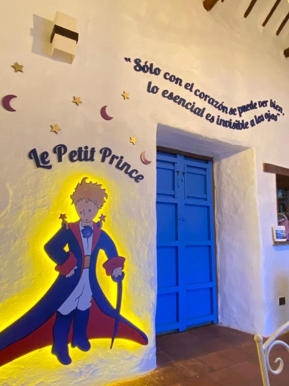 a room with a superhero mural on the wall at El Principito Hospedaje in Barichara
