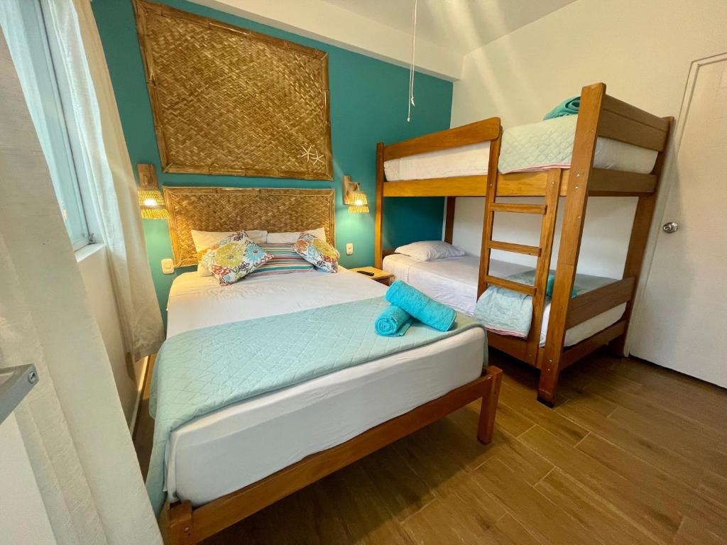 a bedroom with two bunk beds and a ladder at Qeru House in Zorritos