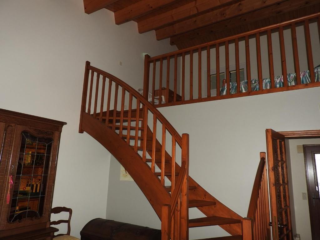 a wooden staircase in a living room with wooden ceilings at Maison Les Sables-d&#39;Olonne, 4 pièces, 6 personnes - FR-1-92-798 in Les Sables-d&#39;Olonne