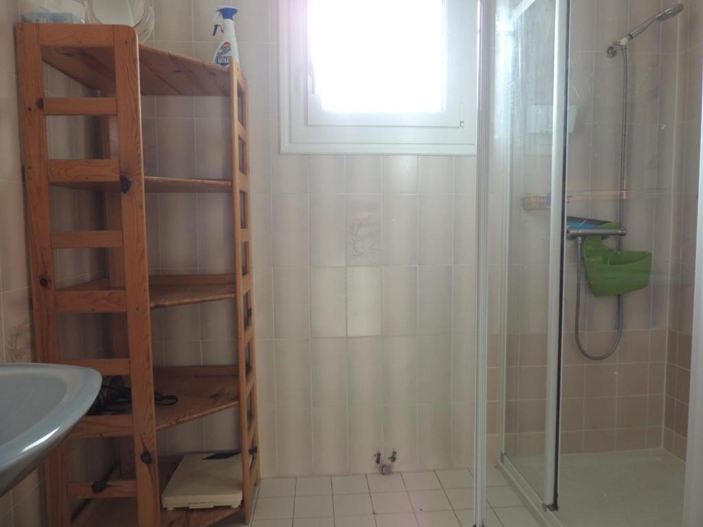 a bathroom with a shower and a sink and a window at Maison Les Sables-d&#39;Olonne, 4 pièces, 6 personnes - FR-1-92-798 in Les Sables-d&#39;Olonne