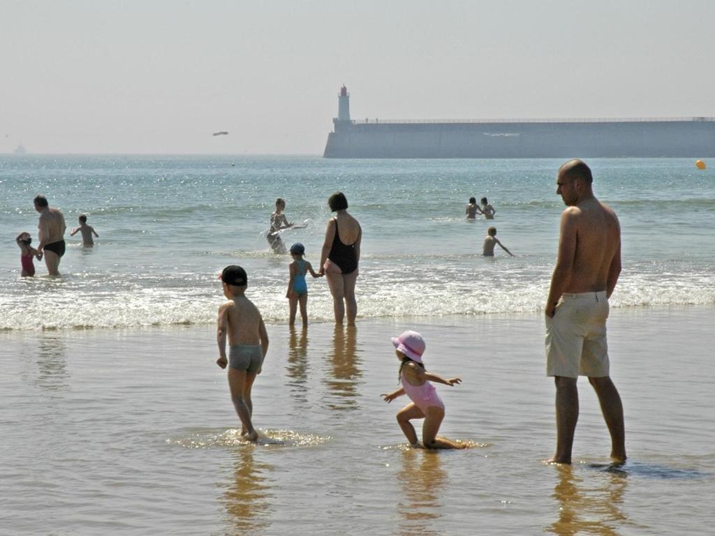 a group of people standing in the water at the beach at Maison Les Sables-d&#39;Olonne, 4 pièces, 6 personnes - FR-1-92-798 in Les Sables-d&#39;Olonne