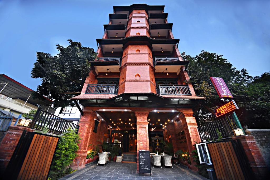 a large building with a tall tower with a patio at Everest Boutique Hotel in Kathmandu