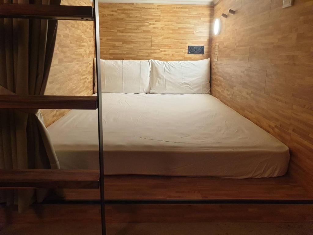 a small bedroom with a bunk bed in a room at NK Hostel in Taipei
