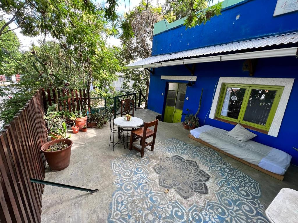 un patio con una mesa y un edificio azul en Lovely studio with stunning terrace, en Tigre