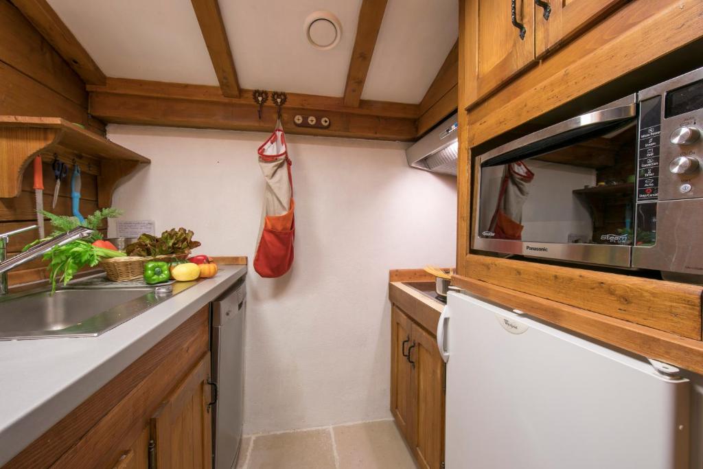 a kitchen with a sink and a microwave at Résidence Améthystes A14 ski-in ski-out - Happy Rentals in Chamonix