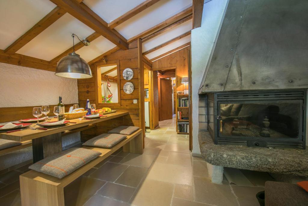 a living room with a fireplace and a dining table at Résidence Améthystes A14 ski-in ski-out - Happy Rentals in Chamonix