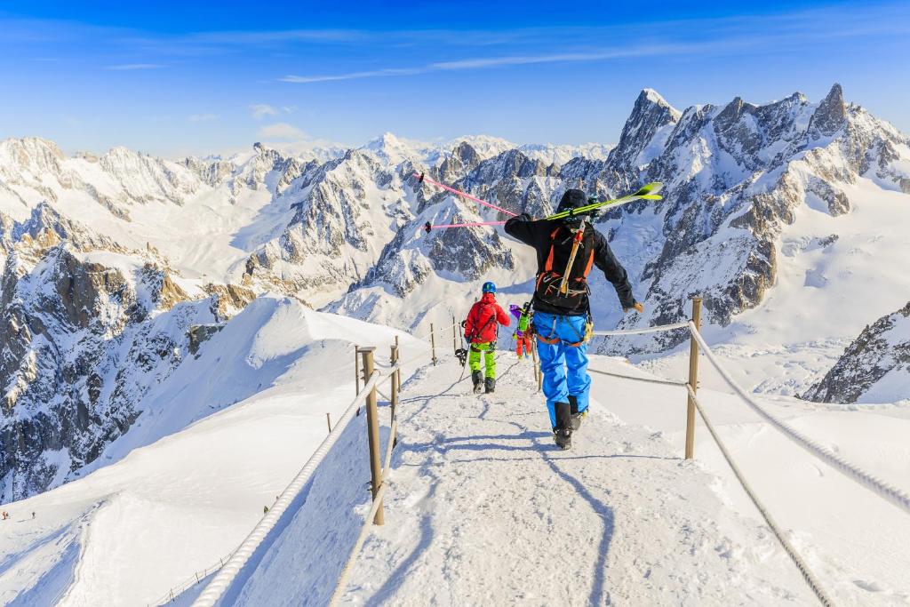a group of people walking up a snow covered mountain at Résidence Améthystes A14 ski-in ski-out - Happy Rentals in Chamonix
