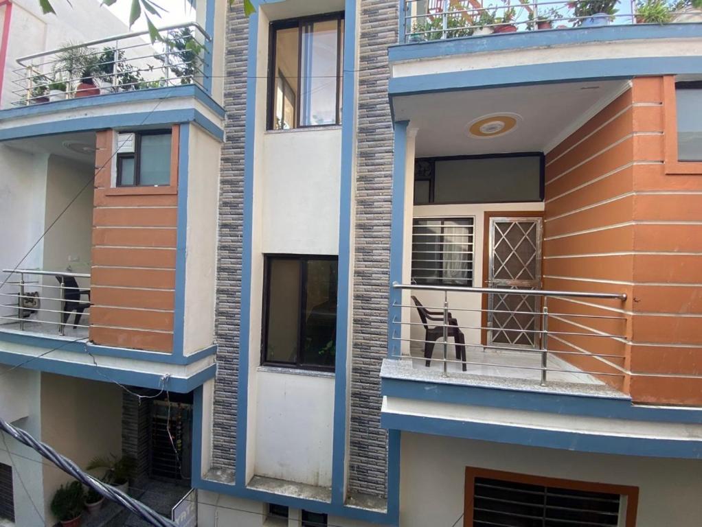 a dog sitting on the balcony of a building at Anvi Home Stay in Rishīkesh