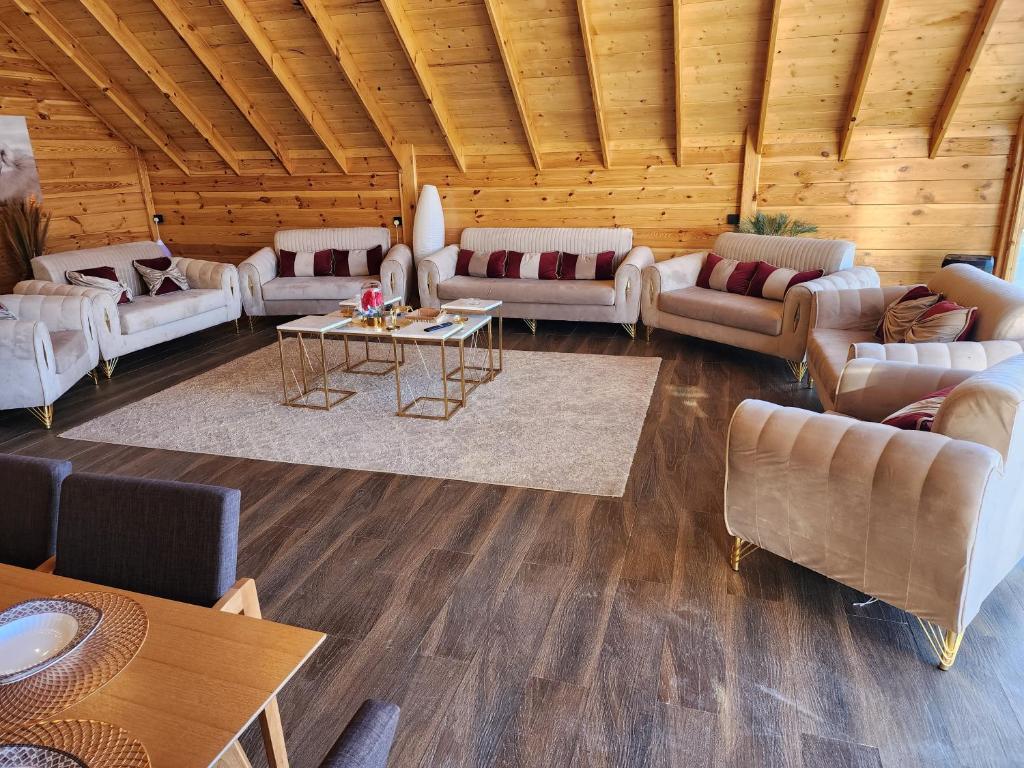 a large living room with couches and a table at منتجع اكواخ كيفا in Tabuk
