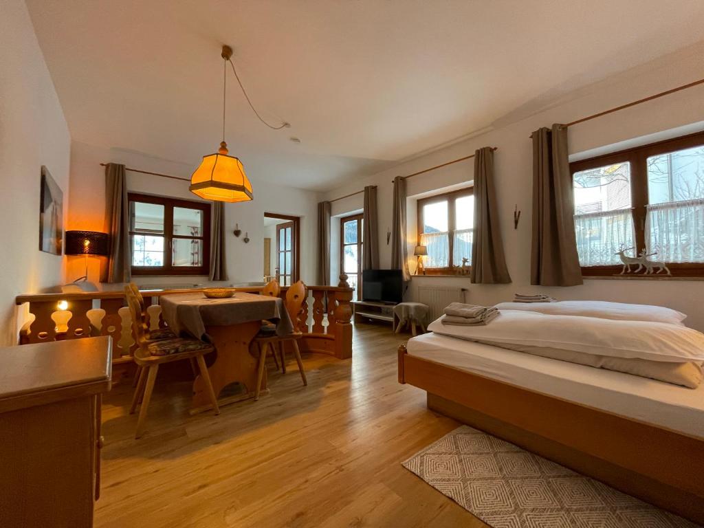 a bedroom with a bed and a dining room at Appartements DIANA in Bad Kleinkirchheim