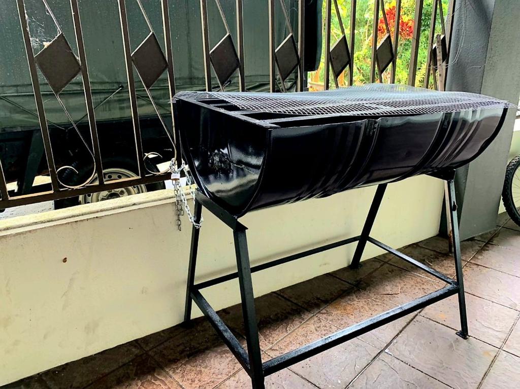 a black iron grill sitting on top of a balcony at Sakura Guest House in Cameron Highlands