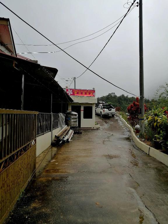an empty parking lot in front of a building at Sakura Guest House in Cameron Highlands