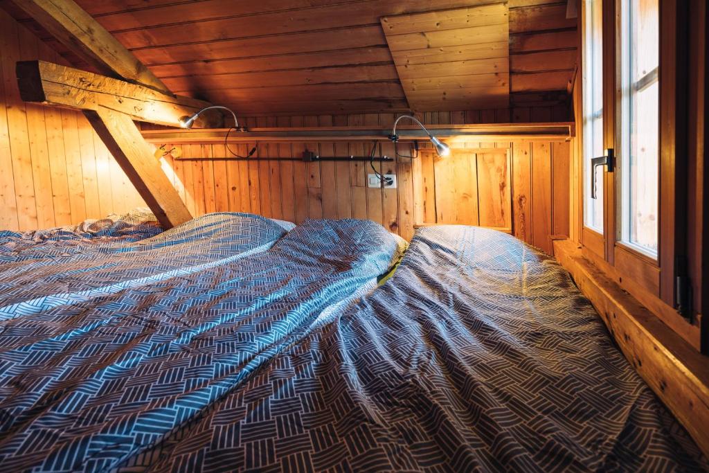 Postel nebo postele na pokoji v ubytování Chalet les Mésanges - Salvan