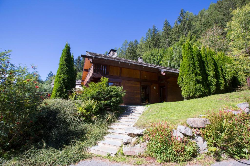 a house on a hill with stairs in front of it at Chalet Résidence Chantey Mourry 67 - Happy Rentals in Chamonix-Mont-Blanc