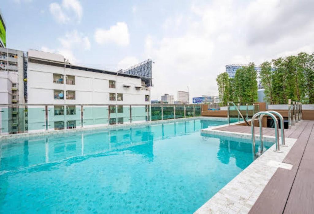 a large swimming pool in front of a building at Hyde Park Hotel Bangkok in Bangkok