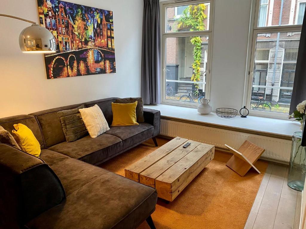 a living room with a couch and a coffee table at Residences Old South in Amsterdam