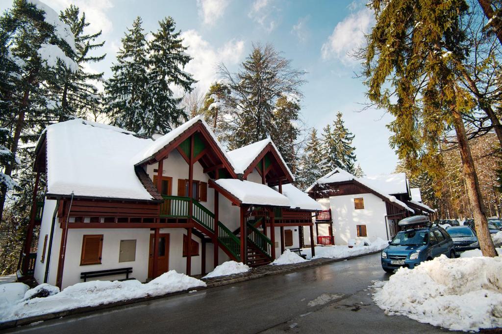 a house is covered in snow at Terme Zreče – Vile Terme Zreče in Zreče