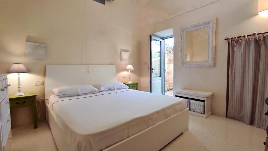 La Dimora di Triano - Aris e Dana tesisinde bir odada yatak veya yataklar