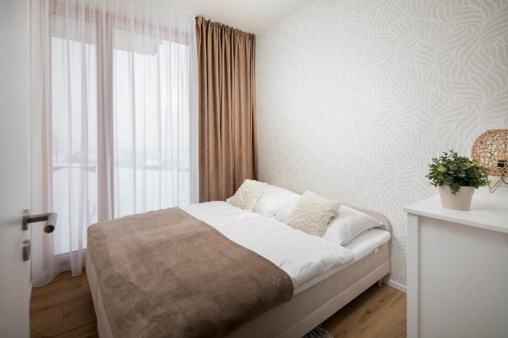 A bed or beds in a room at Apartmán Holia, Kubínska Hoľa