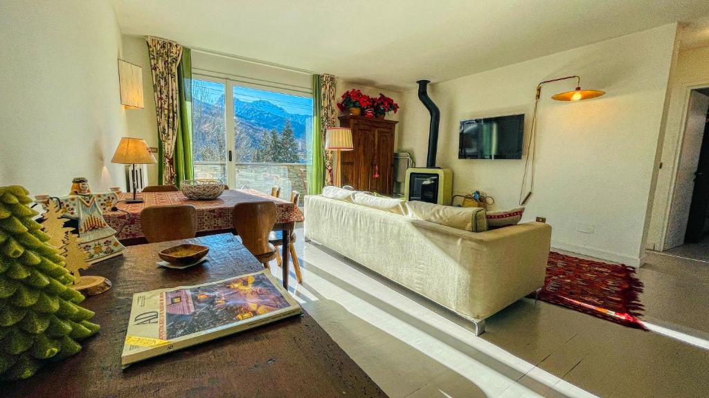 a living room with a couch and a table at La Sequoia - Maison dOc in Bardonecchia
