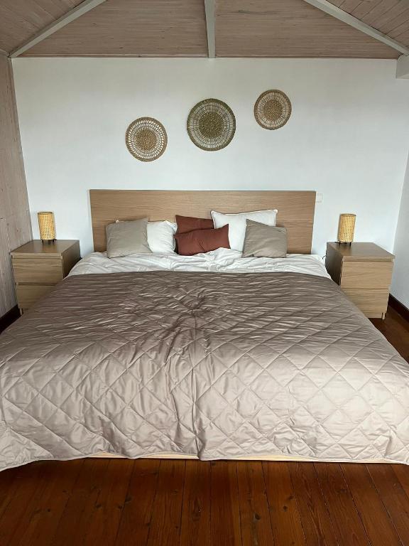 a bedroom with a large bed with two night stands at Gîte Les trois charmes in Gouvy