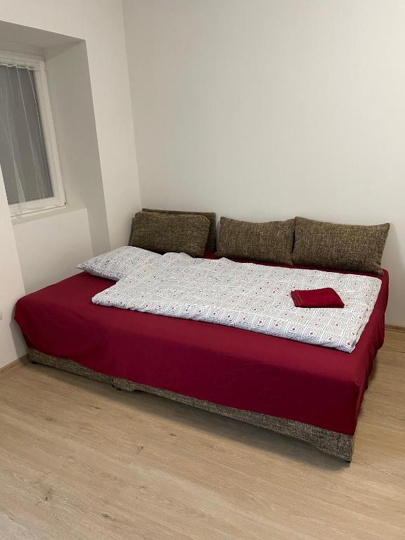 A bed or beds in a room at AA Apartman