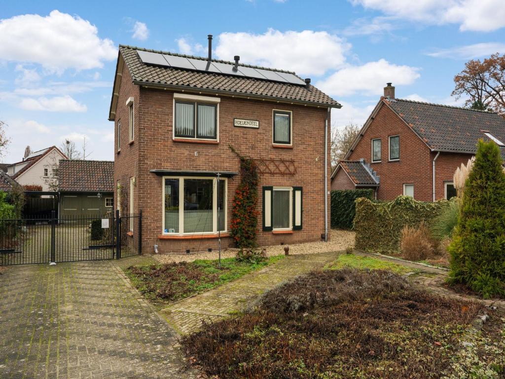 a brick house with a solar roof at Comfortable upstairs apartment with a terrace in Eefde in Eefde