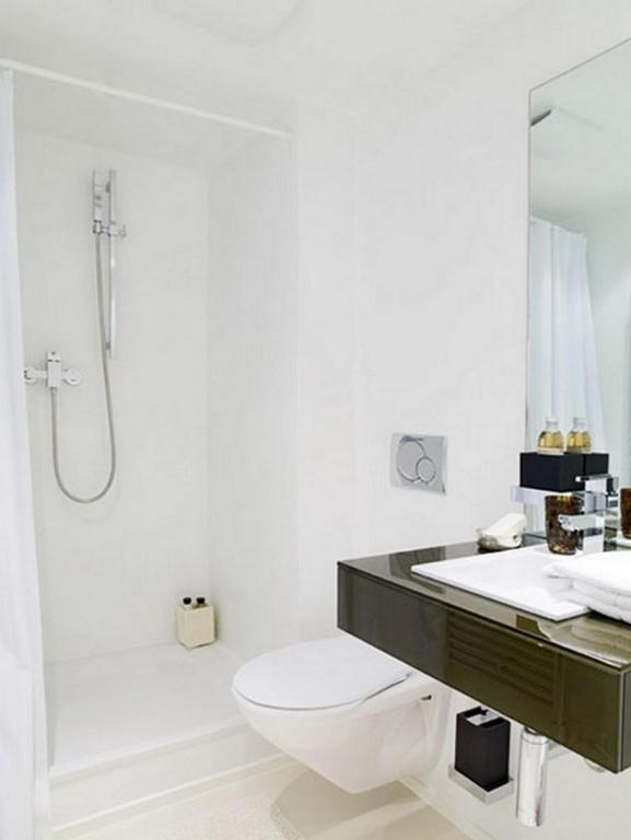 a bathroom with a toilet and a sink and a shower at VISIONAPARTMENTS Binzmühlestrasse 48 - contactless check-in in Zürich