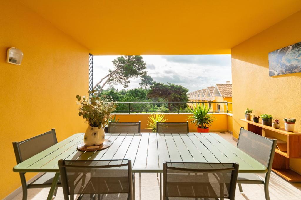 a dining room with a table and chairs on a balcony at Verde Mar Cascais Apartment in Estoril