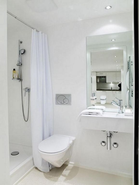 a bathroom with a toilet and a sink and a shower at VISIONAPARTMENTS Binzmühlestrasse 48 - contactless check-in in Zürich