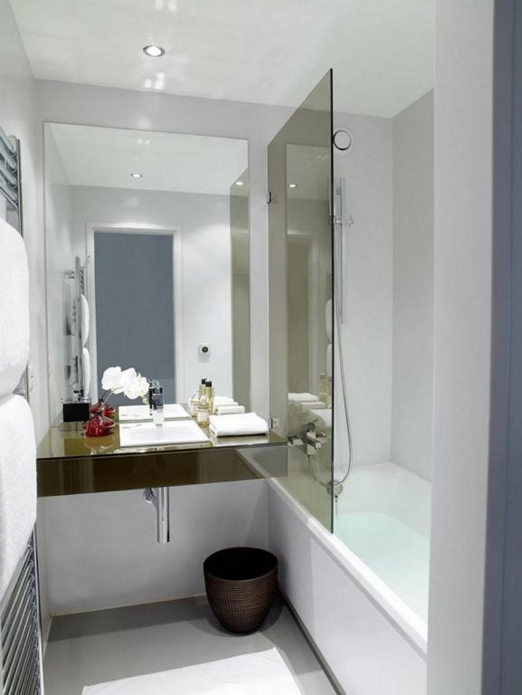 a bathroom with a sink and a mirror at VISIONAPARTMENTS Binzmühlestrasse 48 - contactless check-in in Zürich