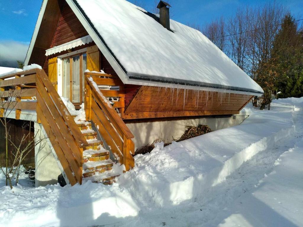 a snow covered cabin with a snow covered roof at Chalet de 2 chambres avec jardin amenage et wifi a Autrans Meaudre en Vercors in Autrans