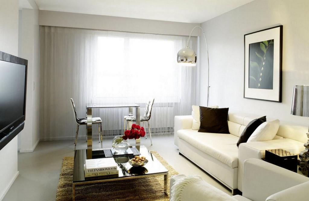 a living room with a white couch and a coffee table at VISIONAPARTMENTS Binzmühlestrasse 48 - contactless check-in in Zürich