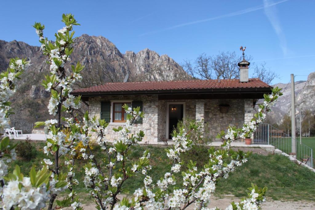 a small house with mountains in the background at Cà del Garì in Tremosine Sul Garda