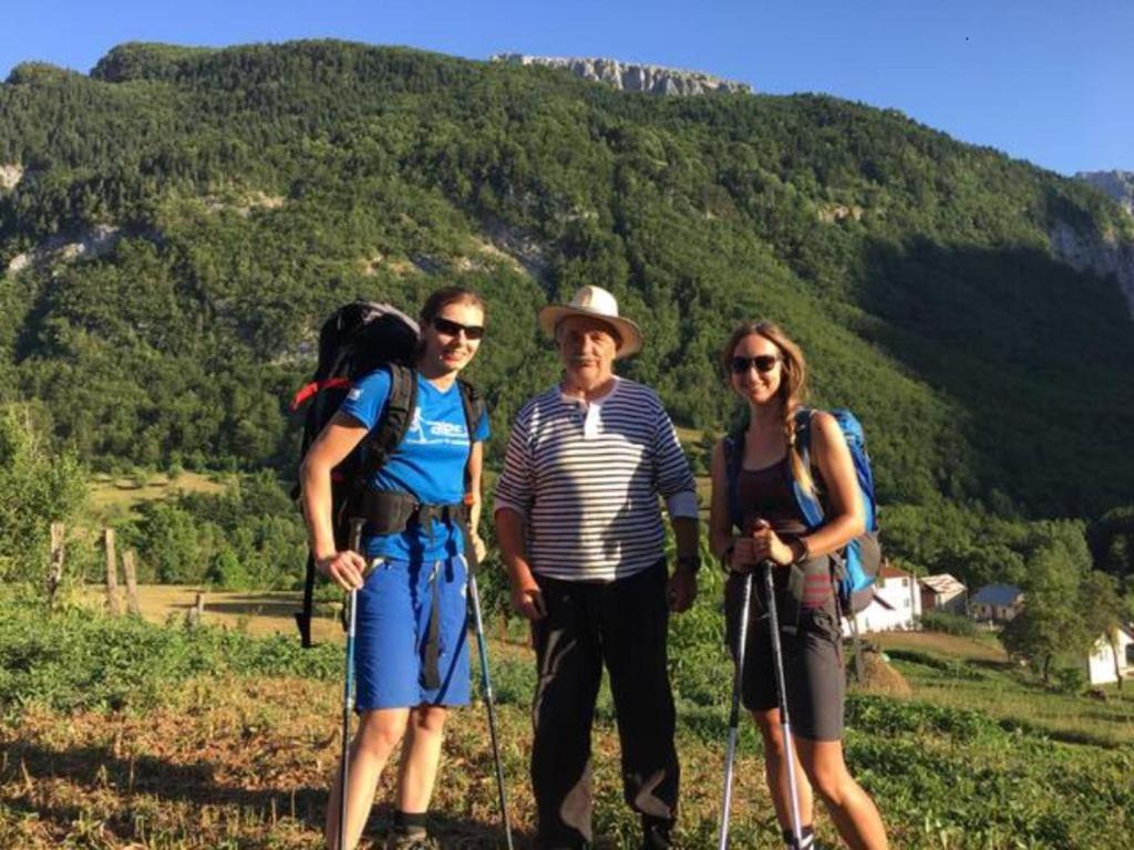a group of three people standing on a mountain at Dedushi Guesthouse &Wood cabins-Camping place in Gusinje
