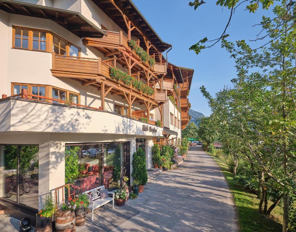 a building with potted plants on the side of it at Fischerwirt am See in Achenkirch