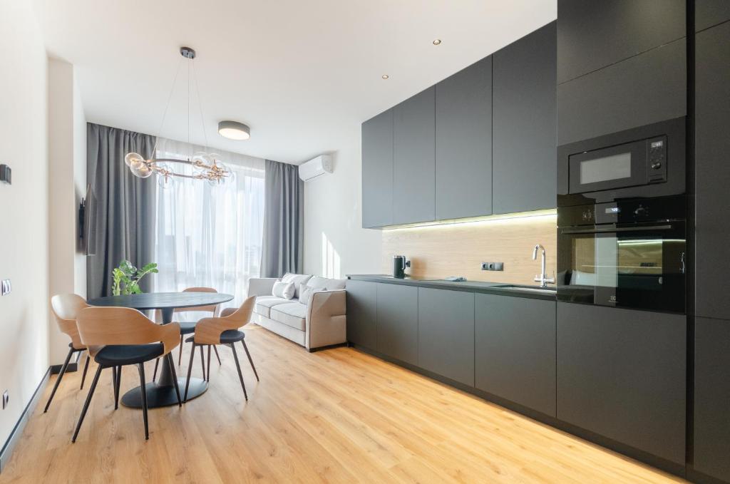 a kitchen and living room with a table and chairs at 18037 Designer apartments in the residential complex "Yaroslaviv Grad" in Kyiv
