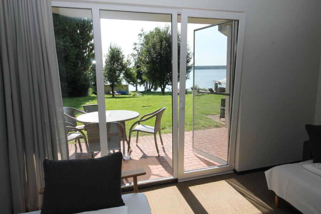 a room with a sliding glass door leading to a patio at Design-Apartment am Plöner See in Ascheberg