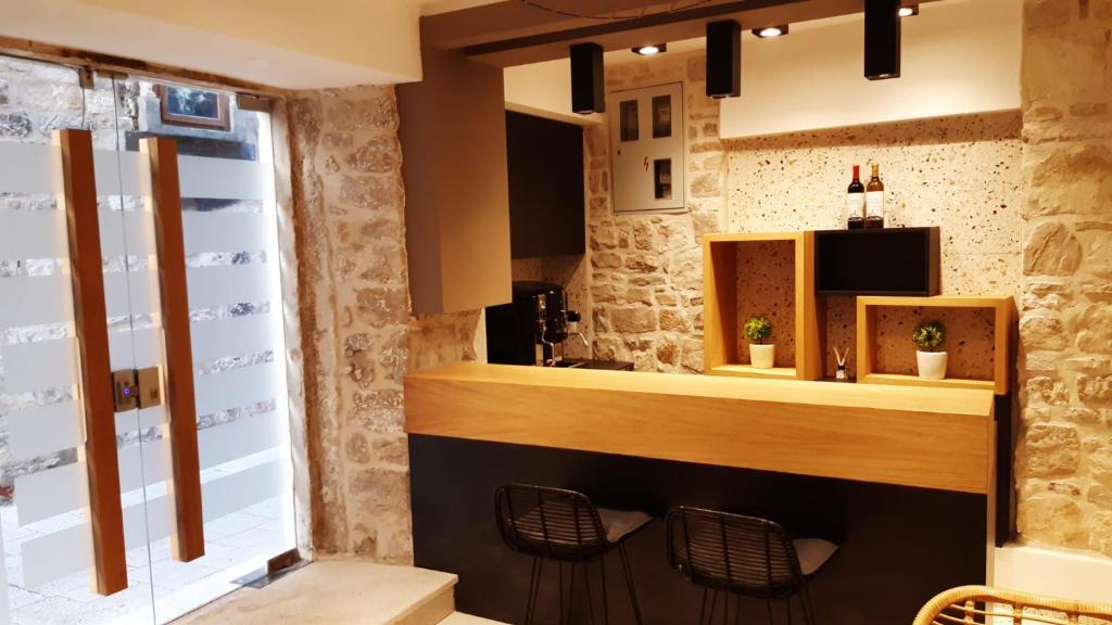 a bar in a room with two chairs and a window at ST. CLARA OLD TOWN in Šibenik