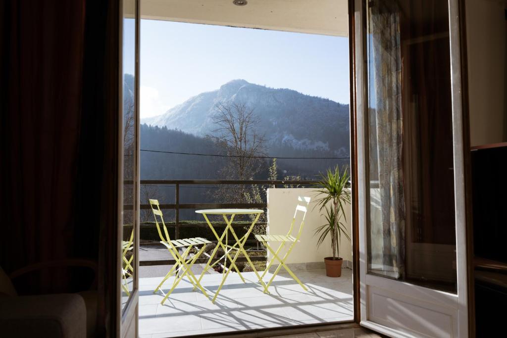 a view of a balcony with a table and chairs at KASA JURA - Au coeur des monts in Saint-Claude