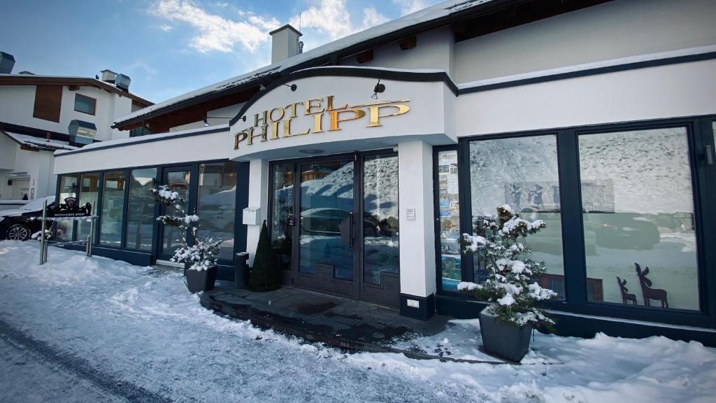 a facade of a building with snow on the ground at Hotel Garni Philipp in Serfaus