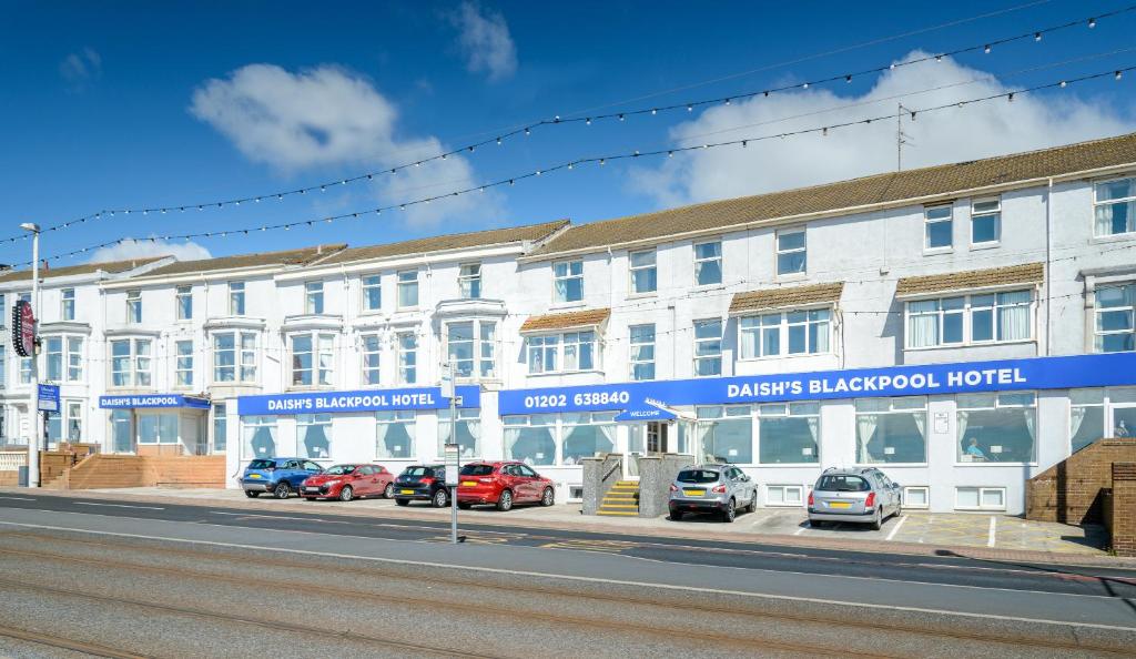 a white building with cars parked in front of it at Daish's Blackpool Hotel in Blackpool