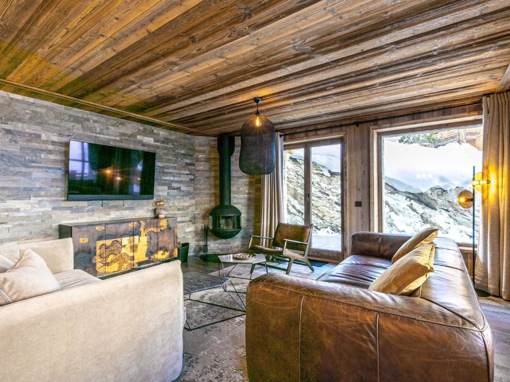 a living room with a couch and a fireplace at Appartement Val-d'Isère, 4 pièces, 8 personnes - FR-1-694-102 in Val-d'Isère