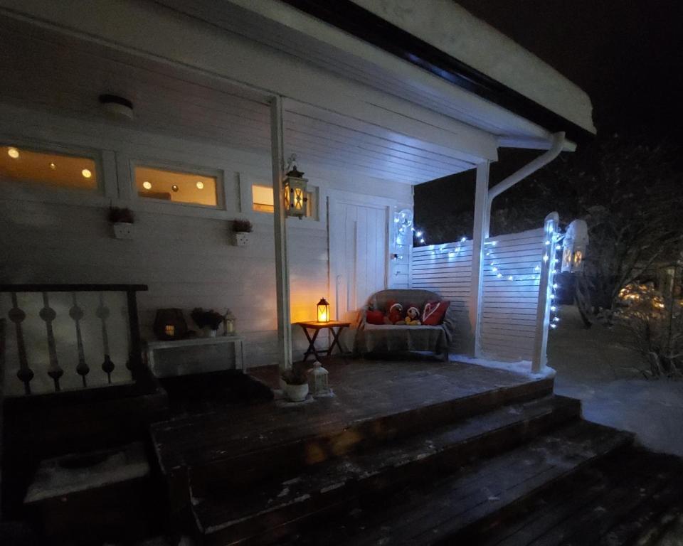 a porch of a house at night with a couch at Blue River in Rovaniemi