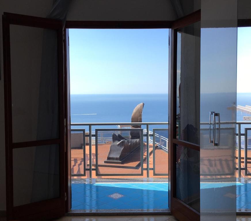 a view from the balcony of a house with a swimming pool at Domus Lavinia in Furore