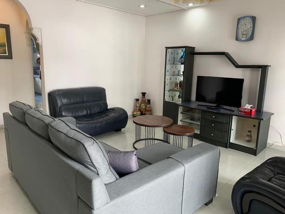 a living room with a couch and a television at Home in Nilai in Nilai