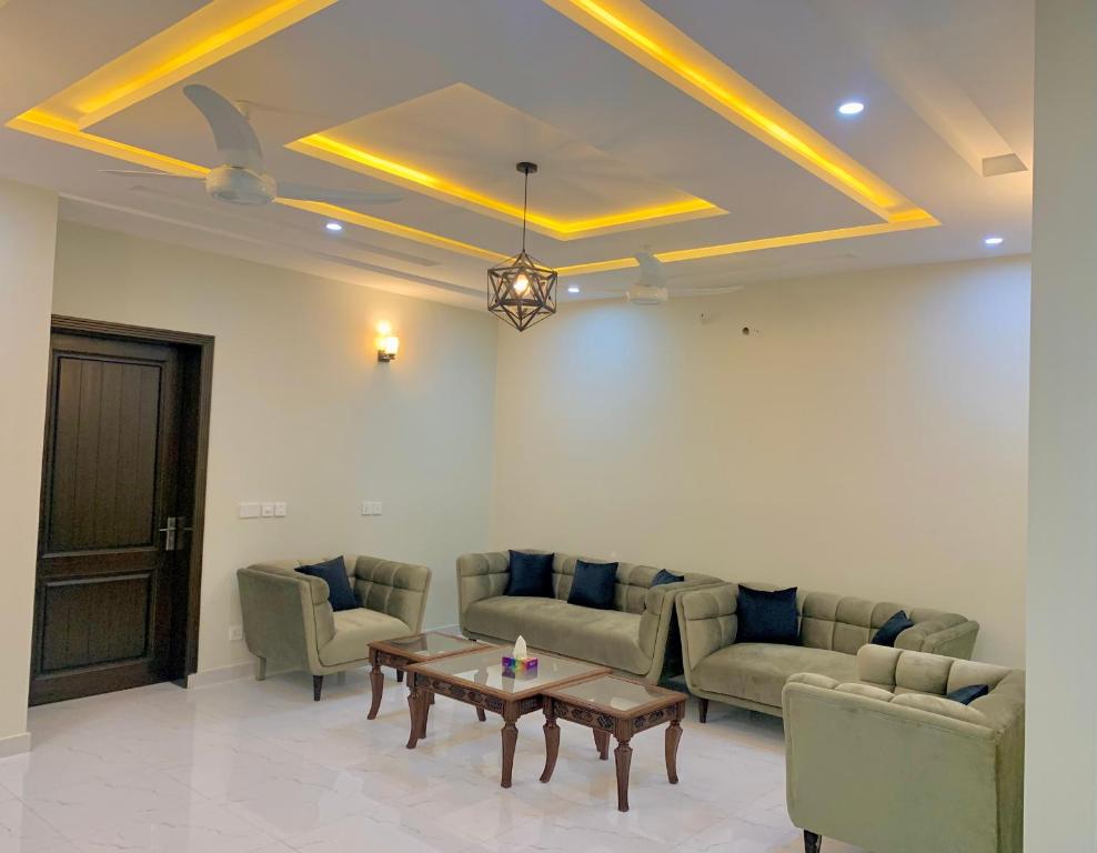 a living room with couches and a coffee table at Bahria Residency in Rawalpindi